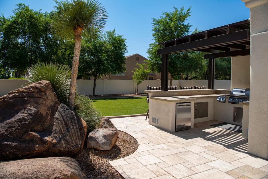 Paver patio with fire pit in a landscaped backyard